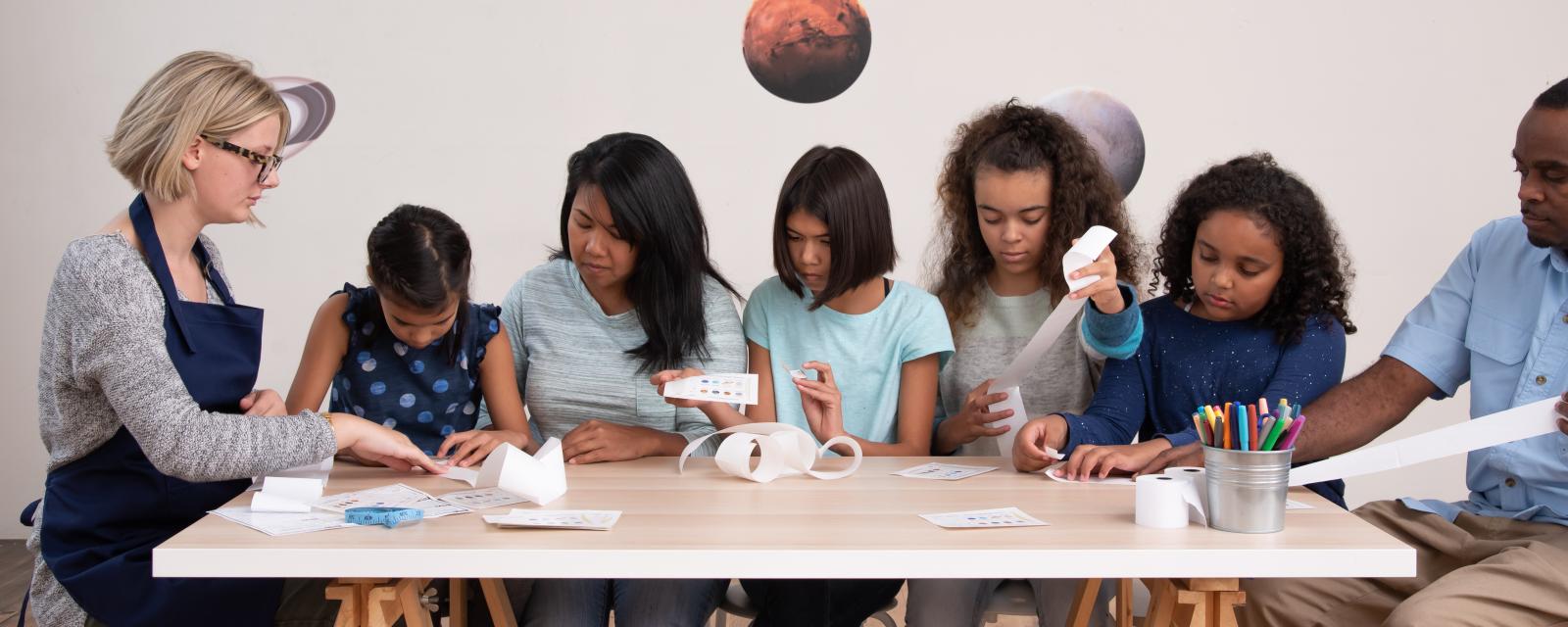 Family doing the Pocket Solar System activity 