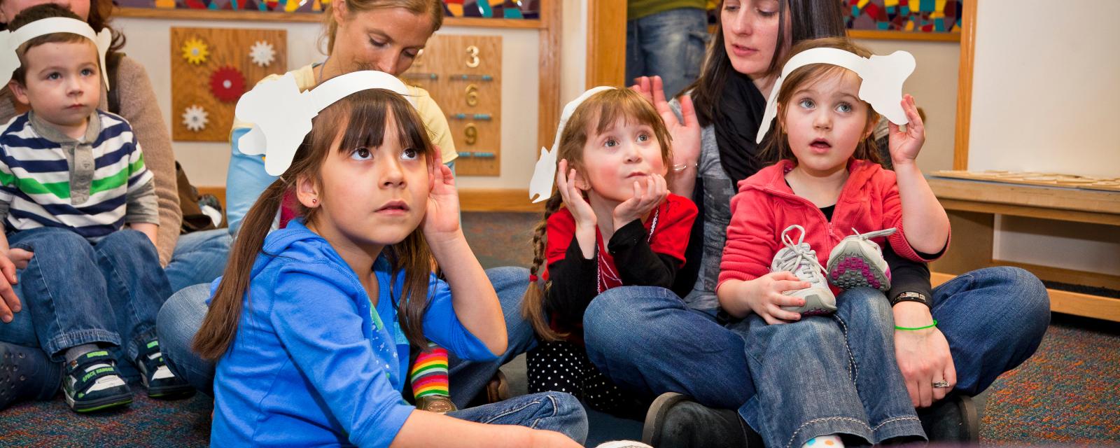 Children listening wearing paper elephant ears in Horton Senses Something Small NanoDays activity