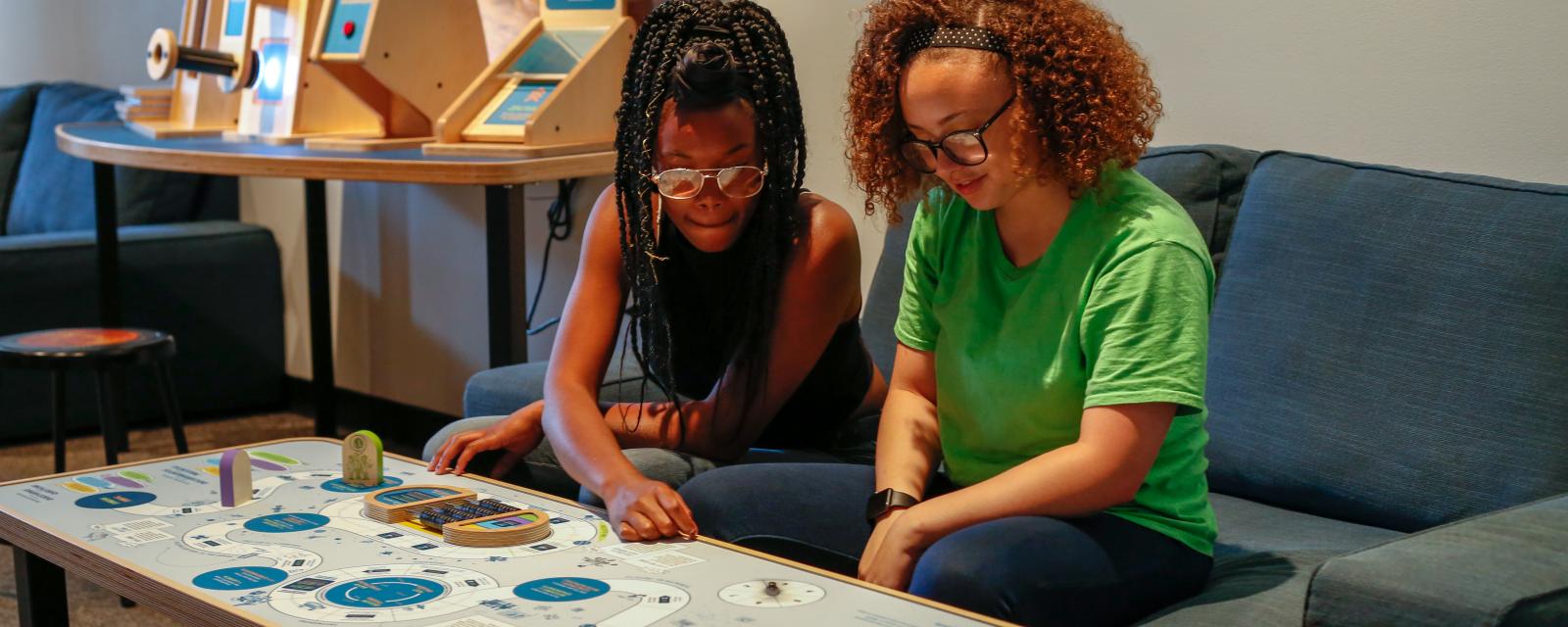 Girls playing space game in Sun Earth Universe exhibition