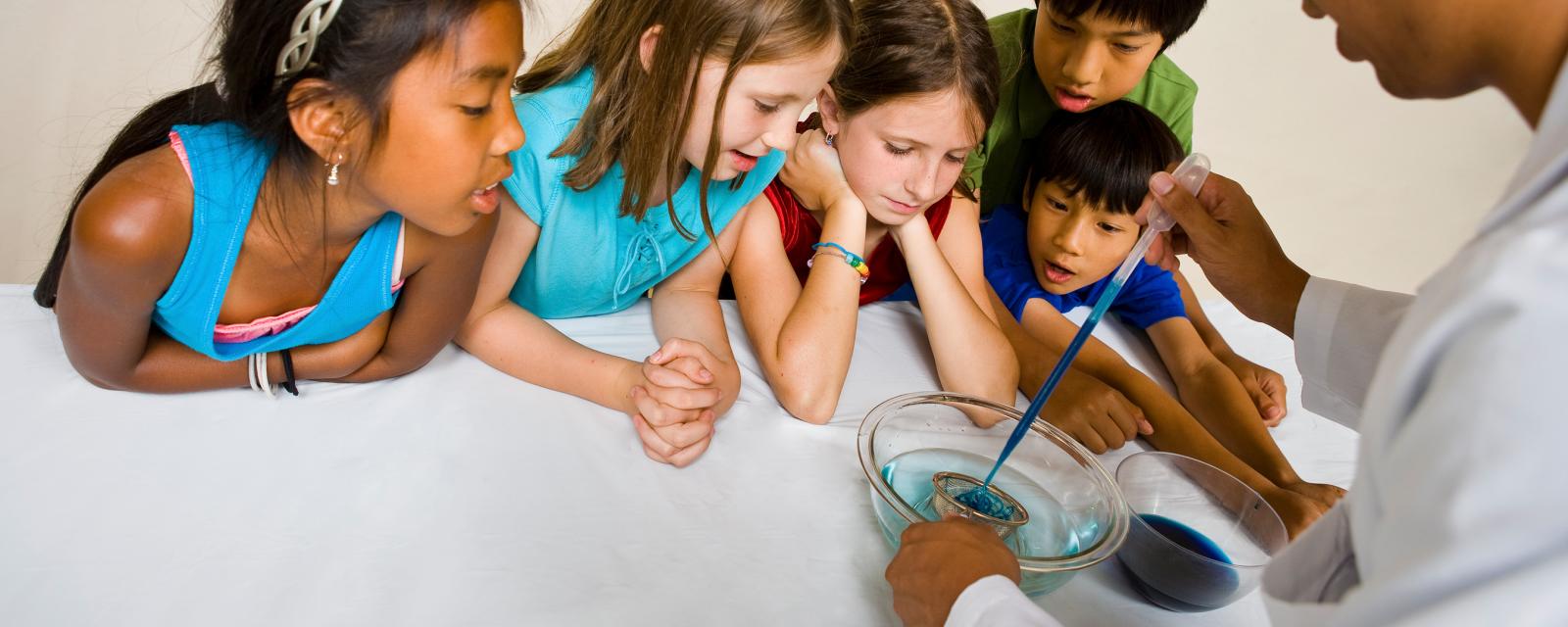 Educator and group of children learning about self assembly using Gummy Capsules NanoDays activity