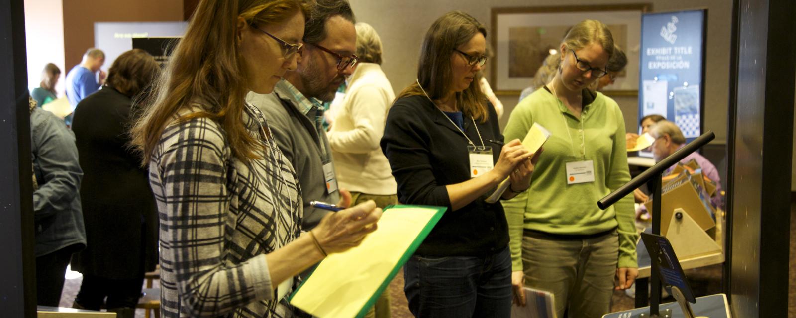 Group of people with clipboards writing