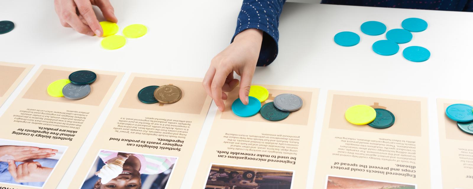 Hands sorting tokens to signify which technology is most important to them