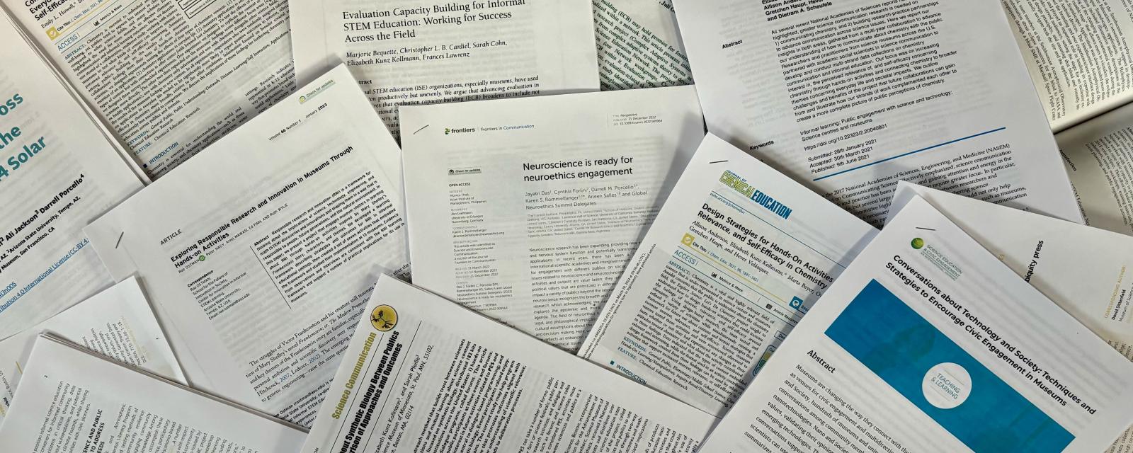 Publications and published papers from the NISE Network projects printed and arranged in a pile