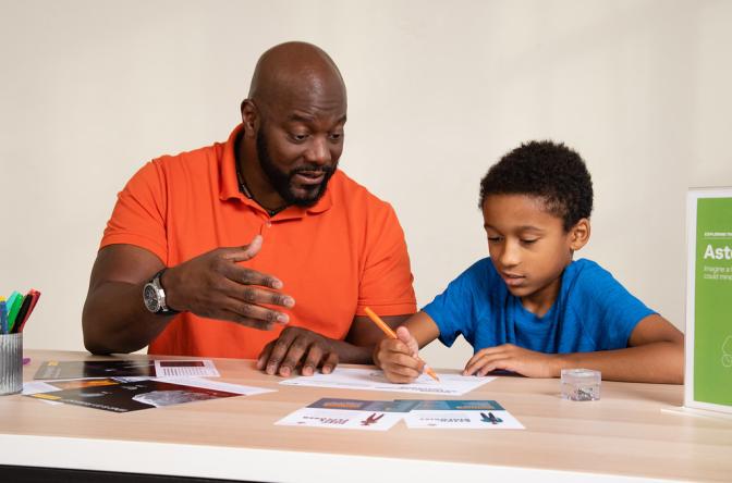 Dad and child talking and creatively drawing using Asteroid Mining Earth and Space activity 