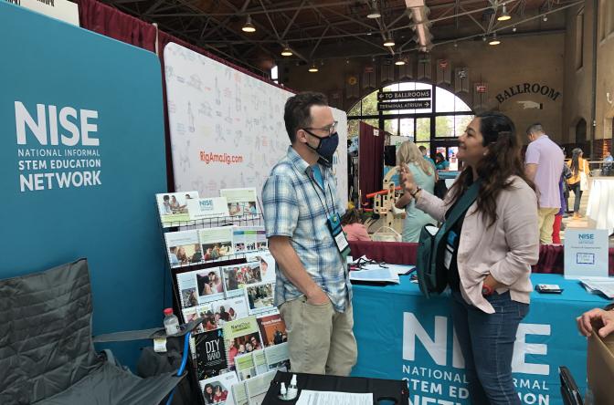Association of Childrens Museums 2022 NISE Network booth people having conversation